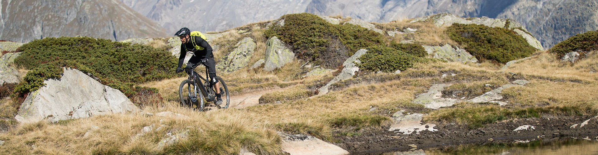 Bergstrom ATV C E-MTB auf dem Aletsch Trail Mann fährt schweizer MTB-Trail auf schwarzem Bergstrom ATV C E-Mountainbike.